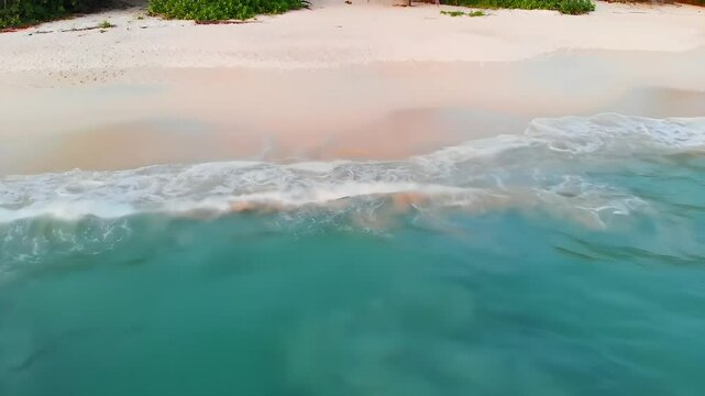 Aerial View of Turquoise Ocean Waves on White Sand Tropical Beach in Bright Sunlight
