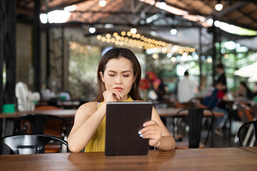 Woman in cafe using digital tablet computer
