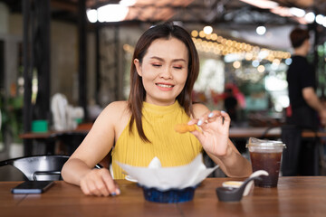 Happy woman eating in restaurant