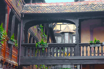 Wooden balcony in inner yard with traditional half-timbered house, Strasbourg, France