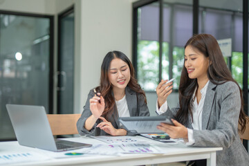  Two businesswoman hands or accountants working together on financial investment on calculator, calculating, analyzing business growth and marketing on graph.