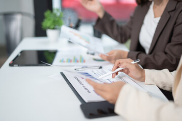  Two businesswoman hands or accountants working together on financial investment on calculator, calculating, analyzing business growth and marketing on graph.