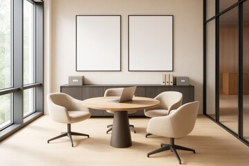 Contemporary office interior with round table, beige chairs, laptop, cabinet, and blank poster frames on wall in bright, clean workspace.