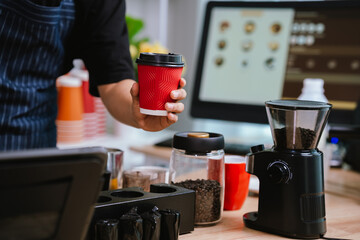 Barista pouring milk into cappuccino, creating latte art in cozy café setting, showcasing morning preparation, craftsmanship, and coffee culture indoors.