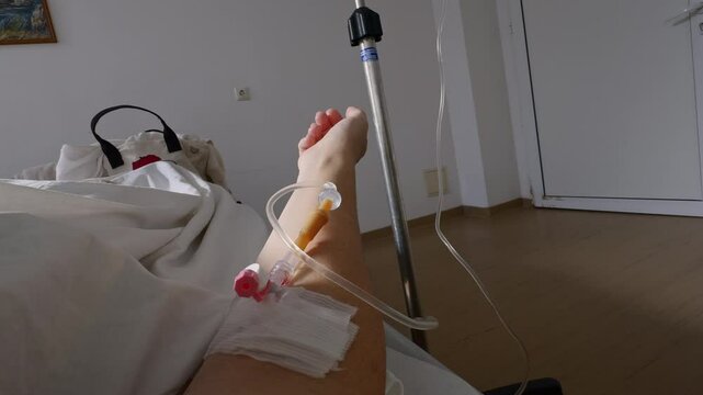 Medical recovery concept featuring woman in hospital bed, IV tube visible in hand, hospital treatment after surgery, sterile room environment, symbol of resilience, support, pain management