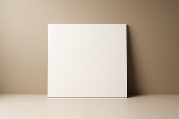 Naklejka premium Blank white square canvas leaning against brown wall in minimal light room, ideal for poster mockup, branding or creative design concept.