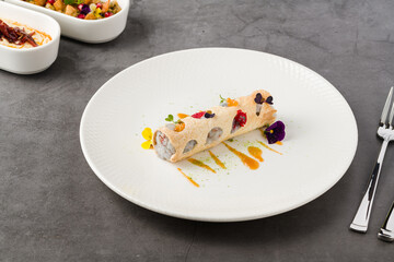 Rolled crispy crepe filled with seafood, herbs, and microgreens
