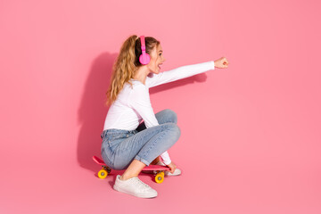Young woman on a skateboard wearing headphones, enjoying leisure and showcasing vibrant energy...