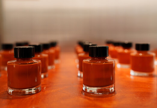 bottle of red pigment on white background