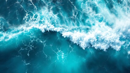 Fototapeta premium Aerial view of dynamic ocean water movement with foamy waves. Ideal for backgrounds, textures, or marine-themed designs in print and digital projects