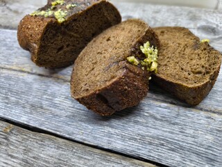 Freshly baked bread with wheat on a rustic wooden table,