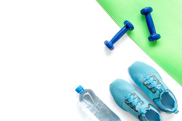 Gym sports equipment with sneakers and dumbbells, top view. Fitness concept