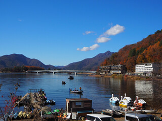 Autumn walk around Lake Kawaguchiko with colorful boats and mountain views, Japan