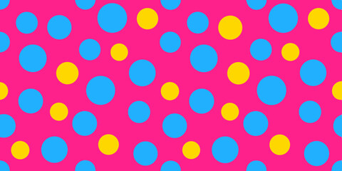 Bright pink background with an arrangement of large blue and yellow polka dots in varying sizes.