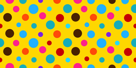 Colorful polka dots in various sizes in pink, blue, brown, and red on a bright yellow background.