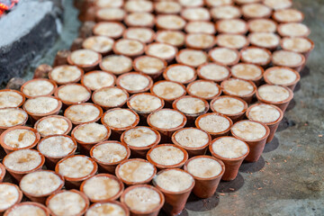 Clay pots around a bonfire to make traditional yogurt, Rajshahi Division, Bogura, Bangladesh. Delicious curd, dahi, doi or bangladeshi sweet yogurt. Mishti doi or Mitha Dahi is a fermented sweet dahi.