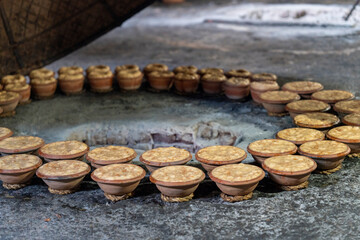 Clay pots around a bonfire to make traditional yogurt, Rajshahi Division, Bogura, Bangladesh. Delicious curd, dahi, doi or bangladeshi sweet yogurt. Mishti doi or Mitha Dahi is a fermented sweet dahi.