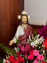 Jesus sculpture in chapel along the St. James way in Arao, Portugal, with flowers