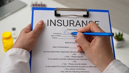 Filling Out Health Insurance Form with Pen in Hand