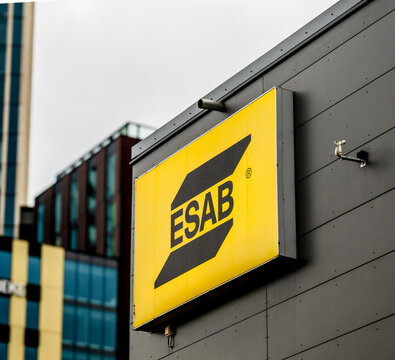 Gothenburg, Sweden - May 24 2025: ESAB logo on yellow signage mounted to building.