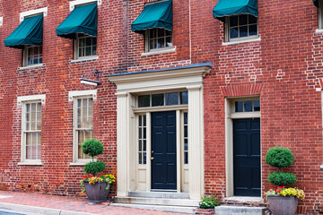entrance of a brick building. Door and windows in old red brick house.