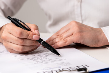 Person Signing an Important Legal Document Carefully