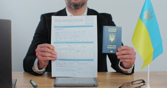 Ukranian embassy officer showing showing visa application and passport, legal immigration, tourist interview.