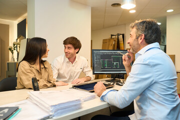 Couple designing home interior with architect advisor in furniture showroom