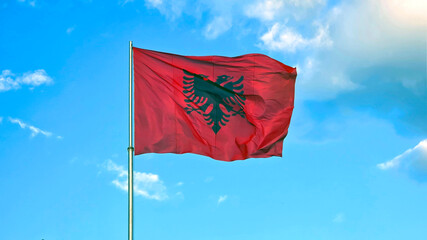Albanian Flag Waving Proudly Against Blue Sky
The national flag of Albania flies high, displaying...