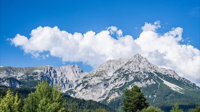 Tyrol Austrian Alps Timelapse: Mountaintops, clouds. Sunny day, majestic Alpine panorama. Wilder Kaiser