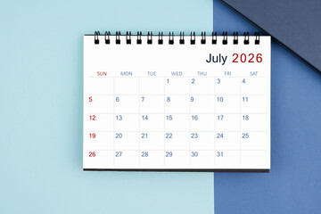 July 2026 monthly desk calendar for 2025 year on blue background.
