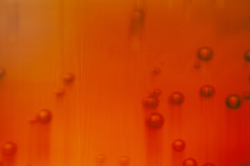 Bright orange liquid filled with fizzy bubbles captures the light