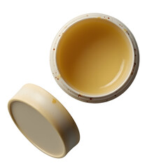 Fototapeta premium Open container with yellow balm inside and lid beside it, showing smooth texture and slight