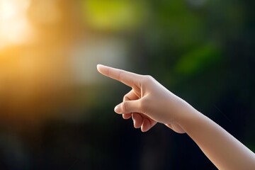 Human Hand Pointing in Air with Warm Blurred Background and Natural Light