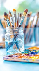 Colorful Paintbrushes in Glass Jar on Artist's Desk