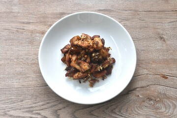 fried slice chicken meat with salt and garlic on plate