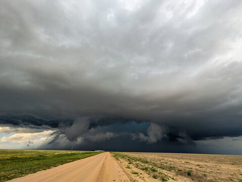 Turquoise Hail Core Peeking Out Behind a Shelf Cloud.