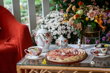Cozy Outdoor Tea Set with Floral Decor and Apple Pie