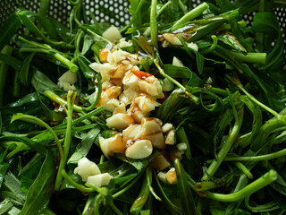 fresh water spinach and morning glory with chopped garlic and chili pepper for stir frying