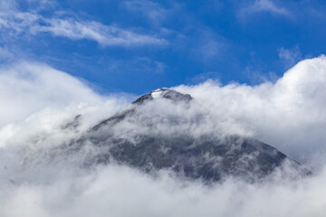 Arenal Cloud- Covered Mountain Peak Against Blue Sky