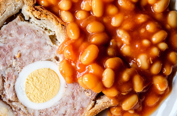 A Slice Of Pork And Egg Classic Gala Pie With Baked Beans