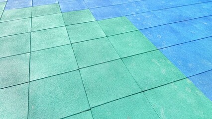 Texture of color rubber floor on playground. Colorful Safety Rubber Floor with Slide and Playground Equipment.