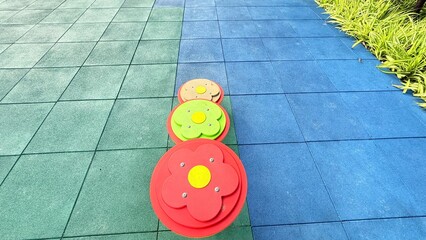 Texture of color rubber floor on playground. Colorful Safety Rubber Floor with Slide and Playground Equipment.