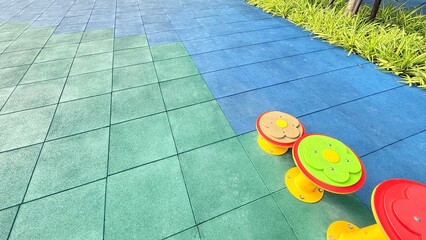 Texture of color rubber floor on playground. Colorful Safety Rubber Floor with Slide and Playground Equipment.