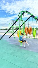 Kid, hanging and monkey bars play outdoors playground, climbing or games with exercise of motor development. Outdoors, development and portrait of kids for playing, freedom and summer adventure with s