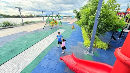 Asian child smiling playing on slider bar toy outdoor playground, exercise of motor development. Outdoors, development and portrait of kids for playing, freedom and summer adventure with smile.