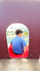 Asian child smiling playing on slider bar toy outdoor playground, exercise of motor development. Outdoors, development and portrait of kids for playing, freedom and summer adventure with smile.