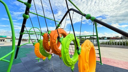Kid, hanging and monkey bars play outdoors playground, climbing or games with exercise of motor development. Outdoors, development and portrait of kids for playing, freedom and summer adventure with s