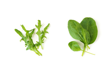 Arugula and spinach leaves isolated on white