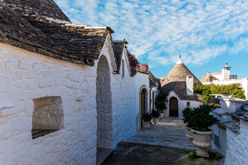 Group of beautiful Trulli, traditional Apulian dry stone hut old houses with a conical roof in...